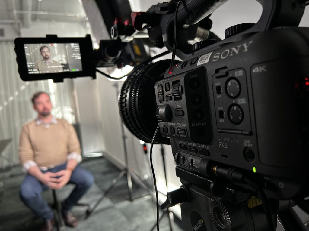 man being interviewed on camera