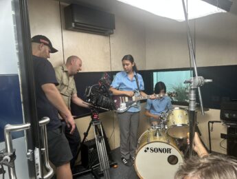 camera crew filming a band